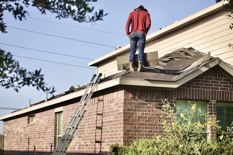 Professional roofer working on a residential roof in North Olmsted